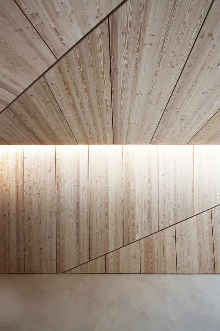 Examples of the home's angular and geometric shaped walls clad with wooden panels
