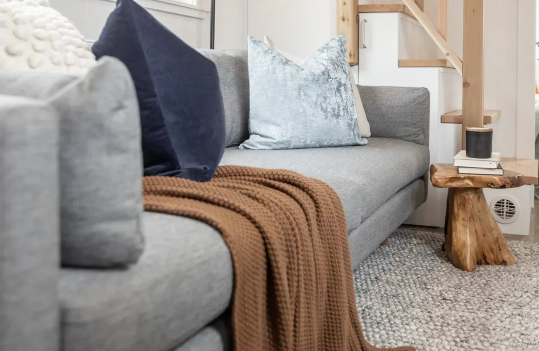 The Loft Ruby Edition's living room includes a sofa and a small coffee table, plus space for a wall-mounted TV