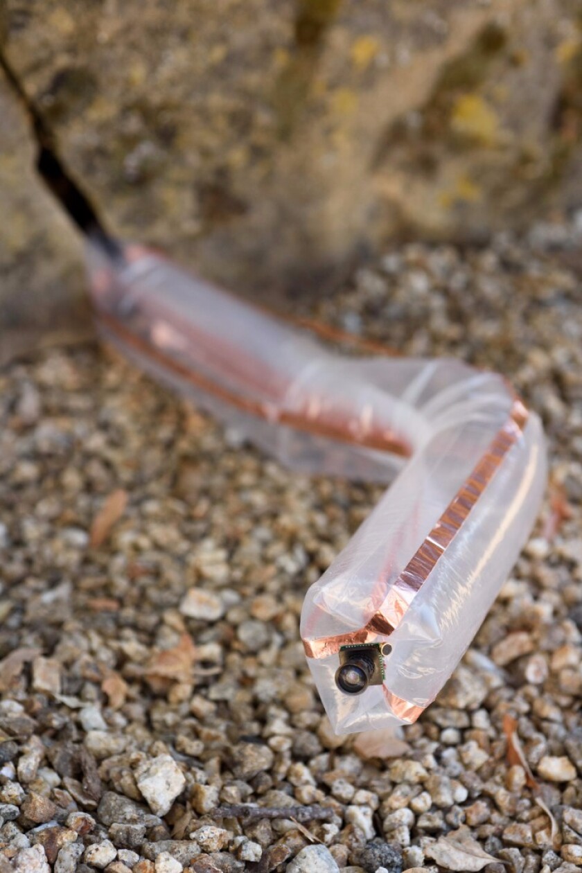 The snake robot is essentially an inside-out tube that grows as it's inflated, guided by a camera on one end