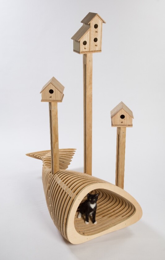 The CAnT WE ALL GET ALONG shelter is designed by HKS. The wooden structure doesn't look all that practical for keeping out the elements but has a novel fish shape and bird houses on its roof