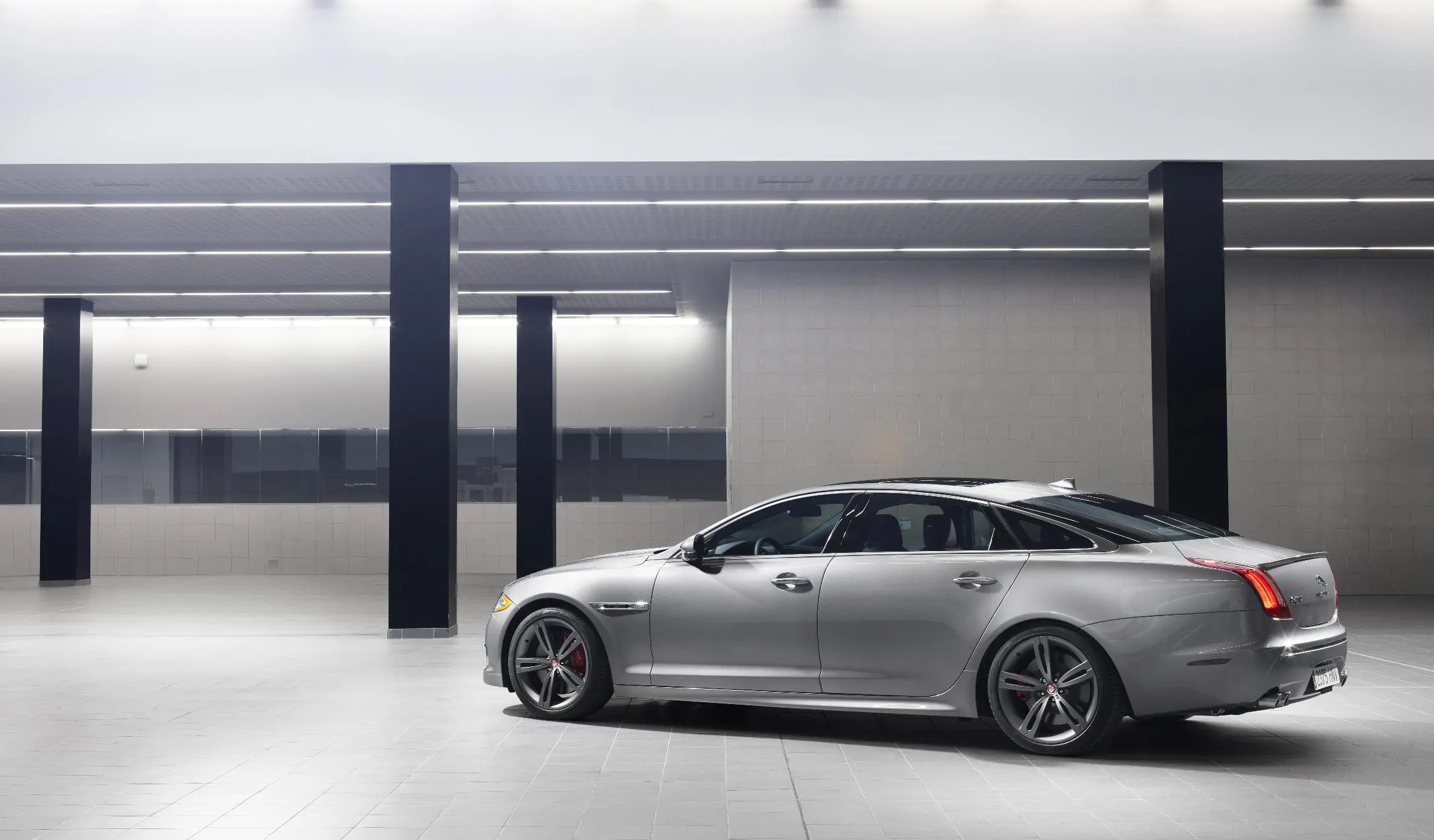A long fast, decreasing roofline finishes off the XJR while a stretched out C-pillar pointedly intersects where the roofline and spoiler-lipped trunk-lid meet
