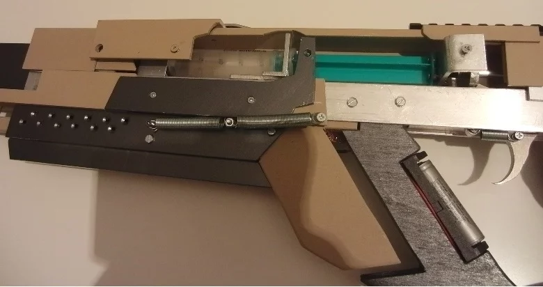 A close-up view of the syringe (green), which forces air down the barrel