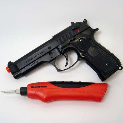 The HFC M9 Spring Airsoft Gun Pistol and RadioShack cordless soldering iron before being dismantled and merged into one
