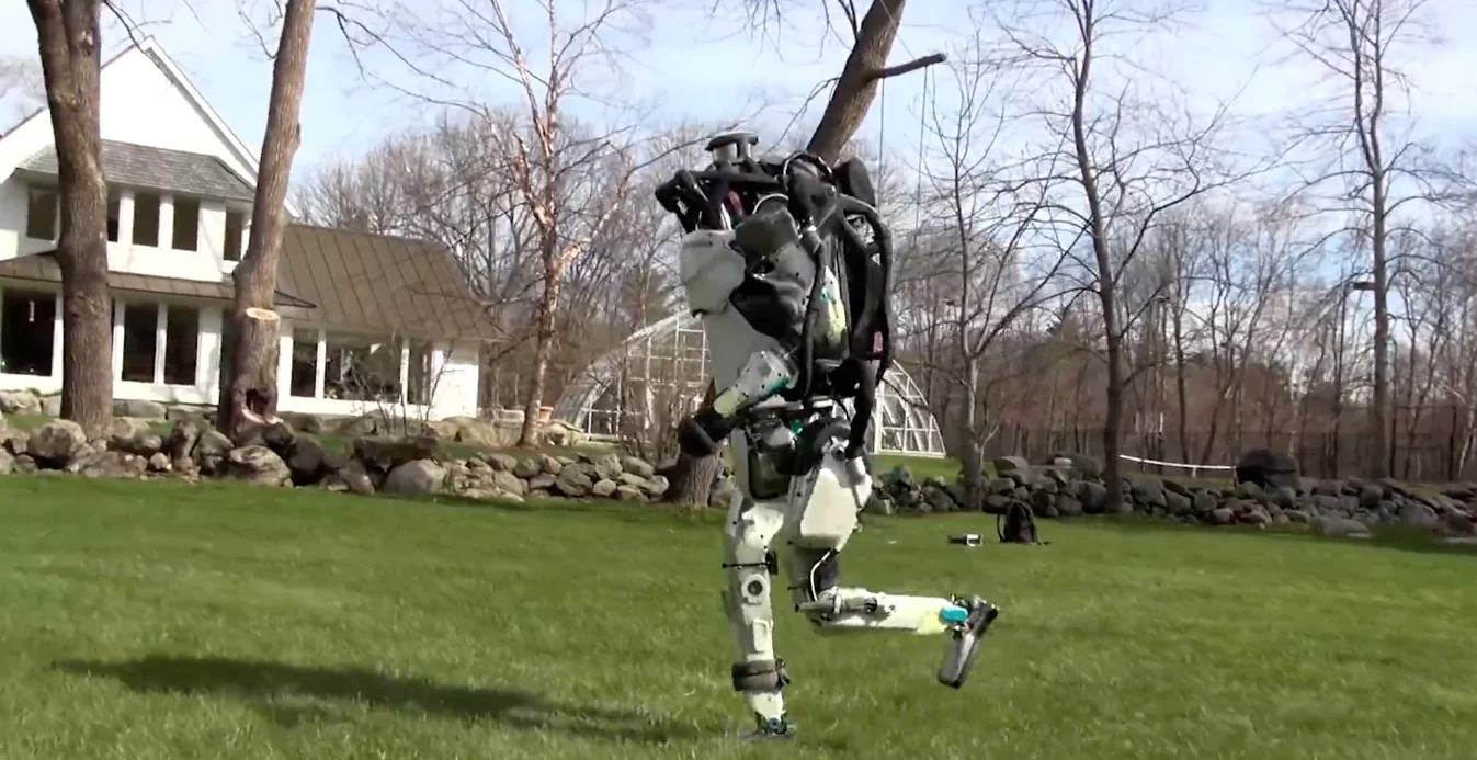 Boston Dynamic's humanoid Atlas robot is shown taking a jog through the woods in a new video