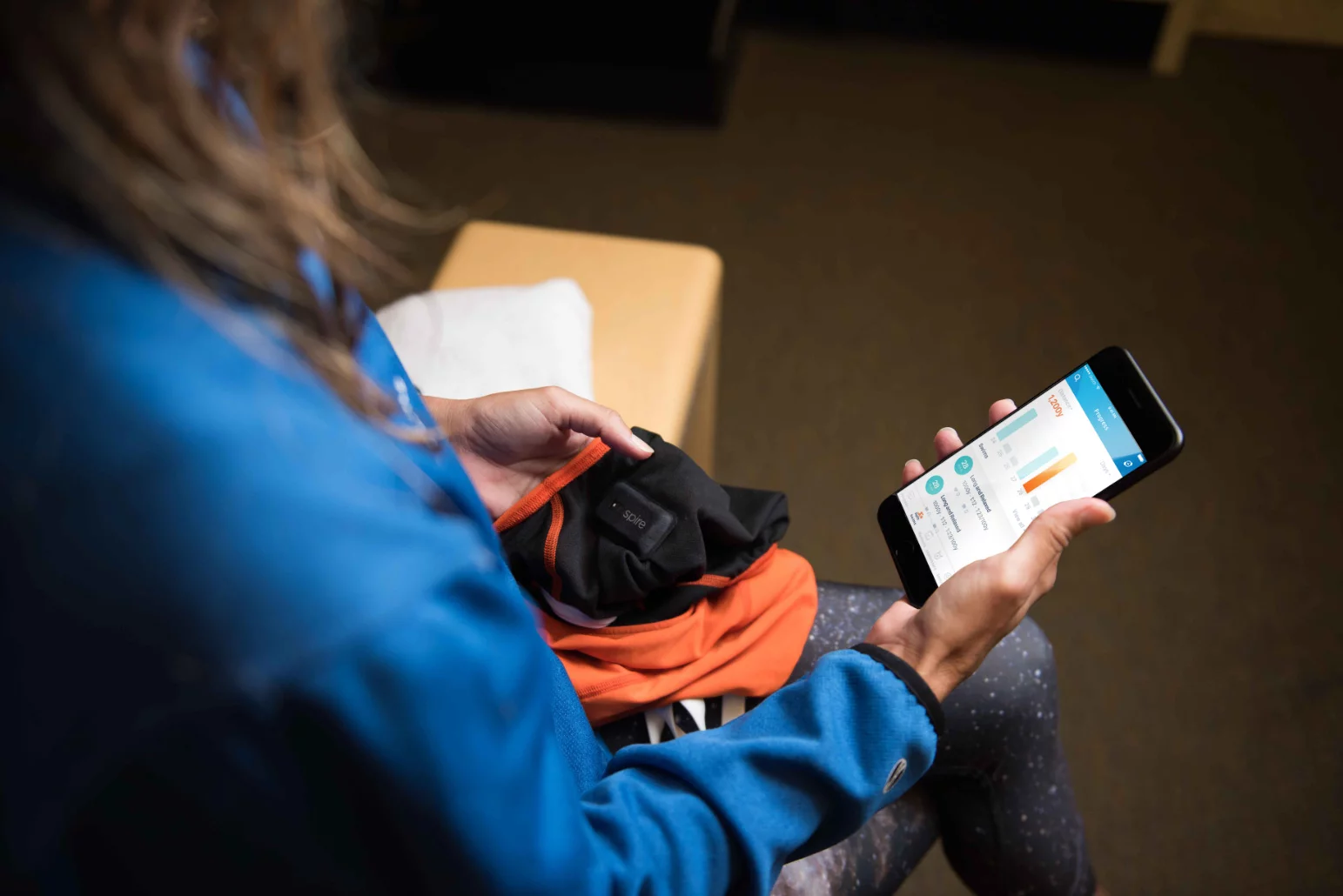 After one-time setup, the smart swimsuit's tracker auto syncs with a smartphone running a companion app over Bluetooth