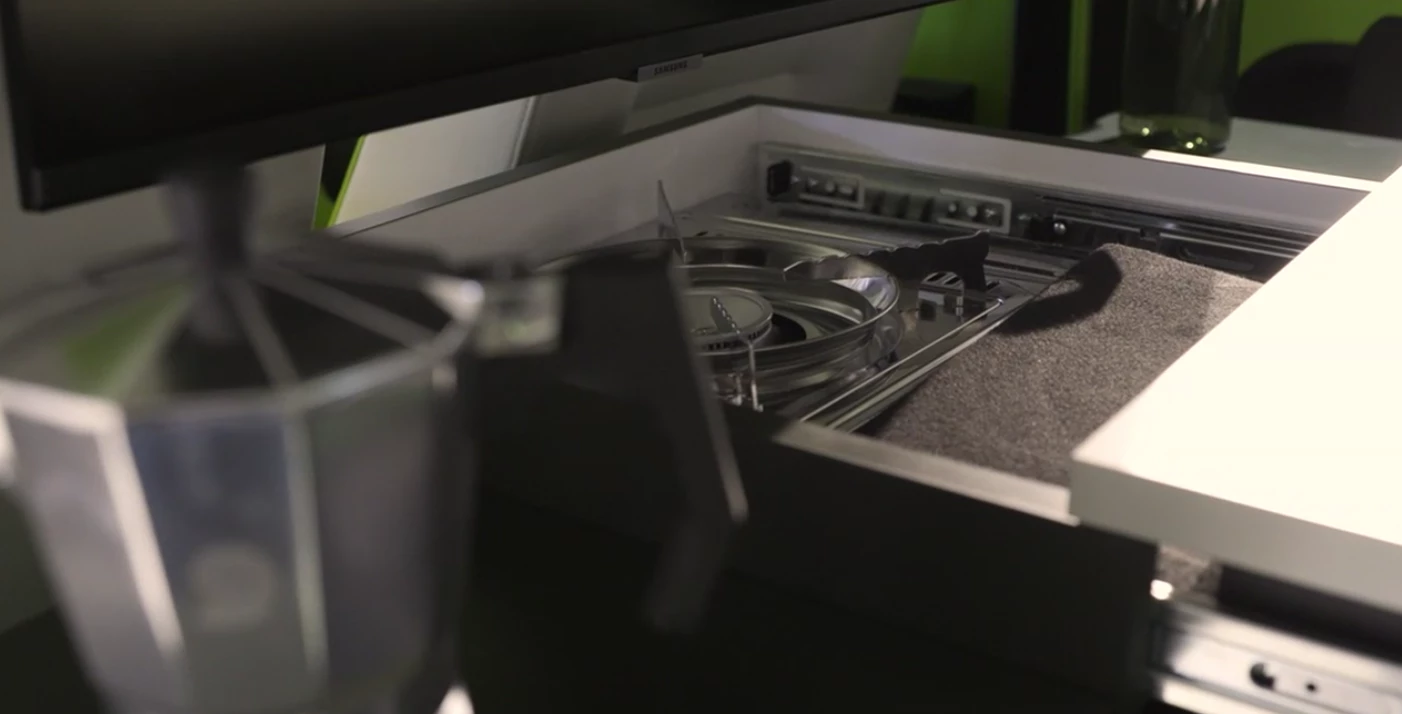 The Xbus Camper conceals a single-burner stove below its slide-out kitchen top