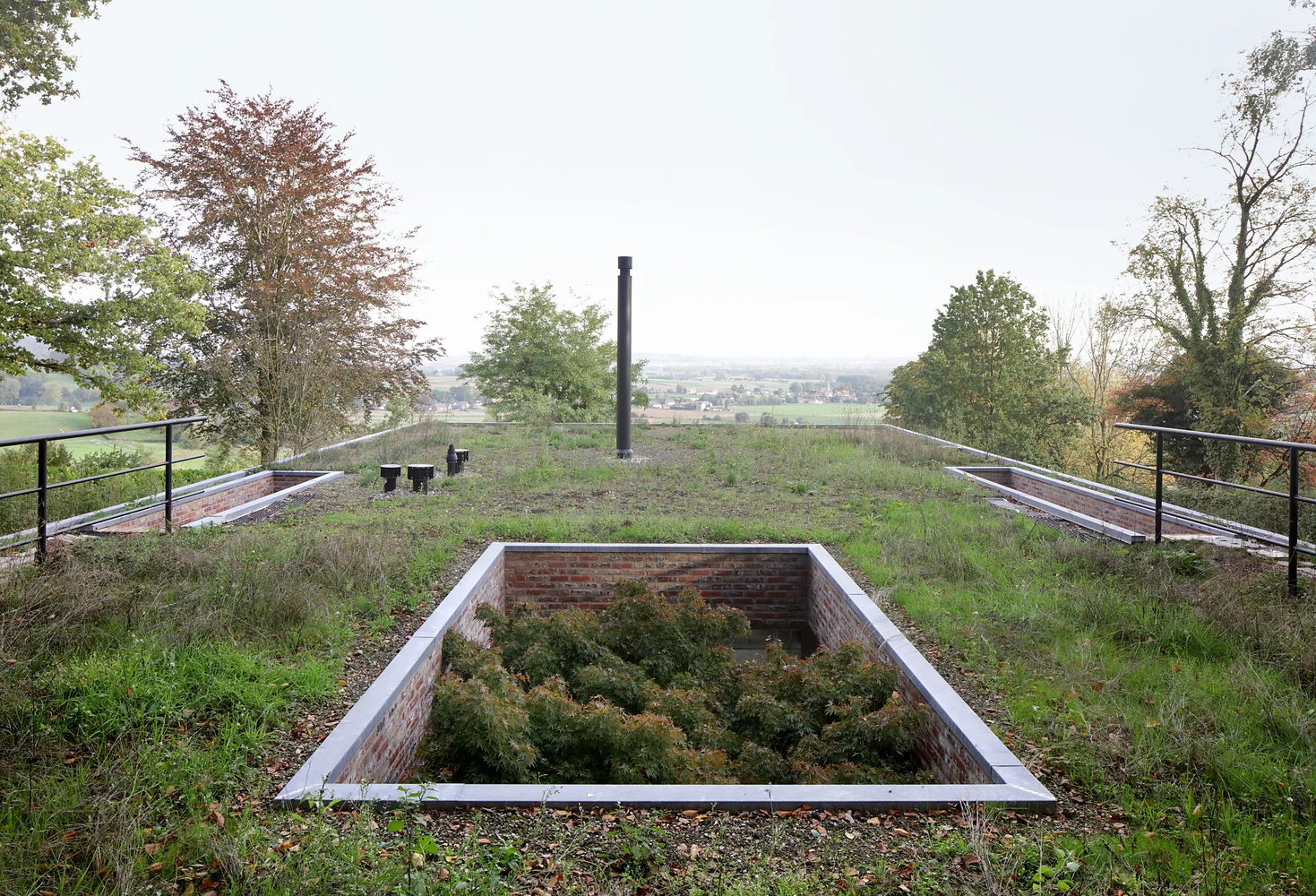 Dutch architectural firm Studio Okami has recently completed a green roof home that vanishes into its natural landscape setting