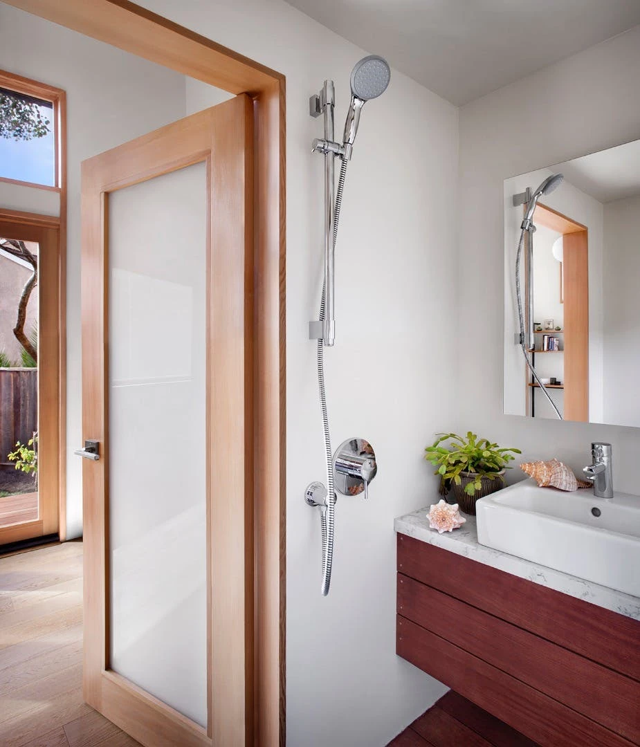 The snug bathroom inside the Britespace flatpack home includes a shower, toilet, and sink