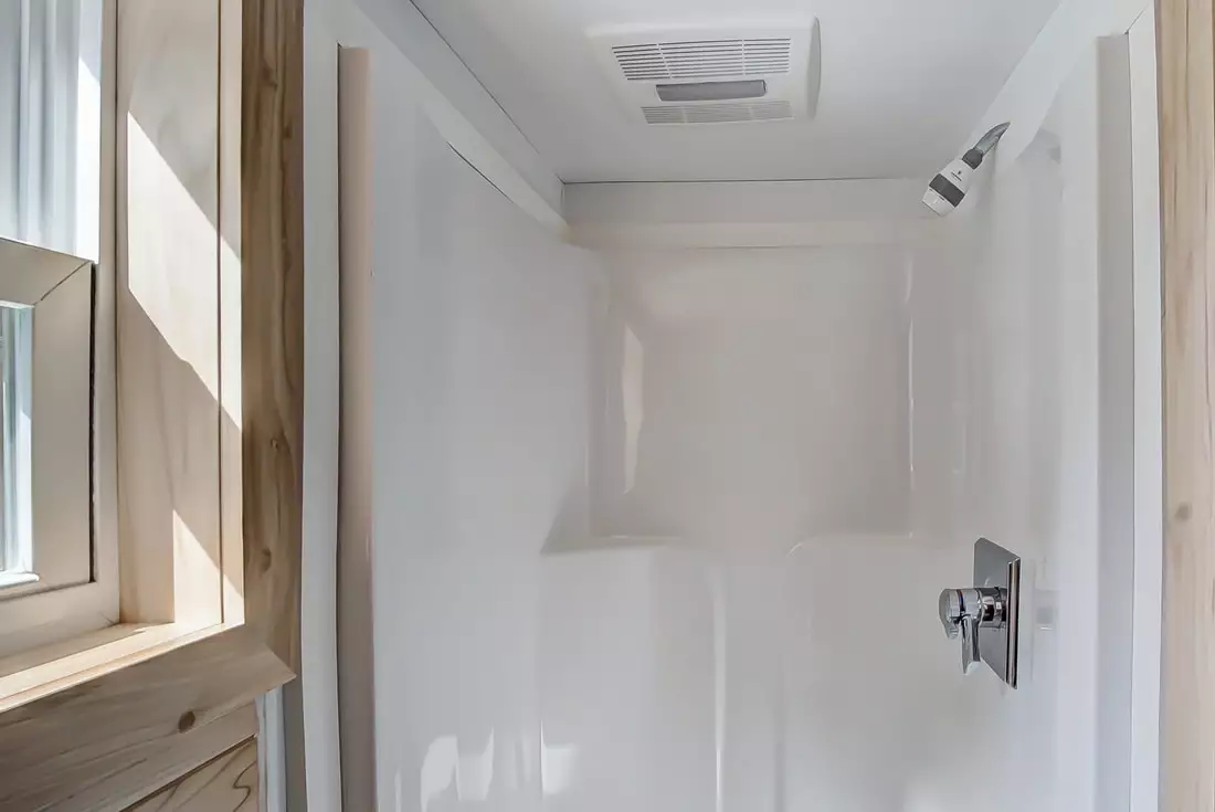 The Clover's bathroom includes toilet, sink, and shower