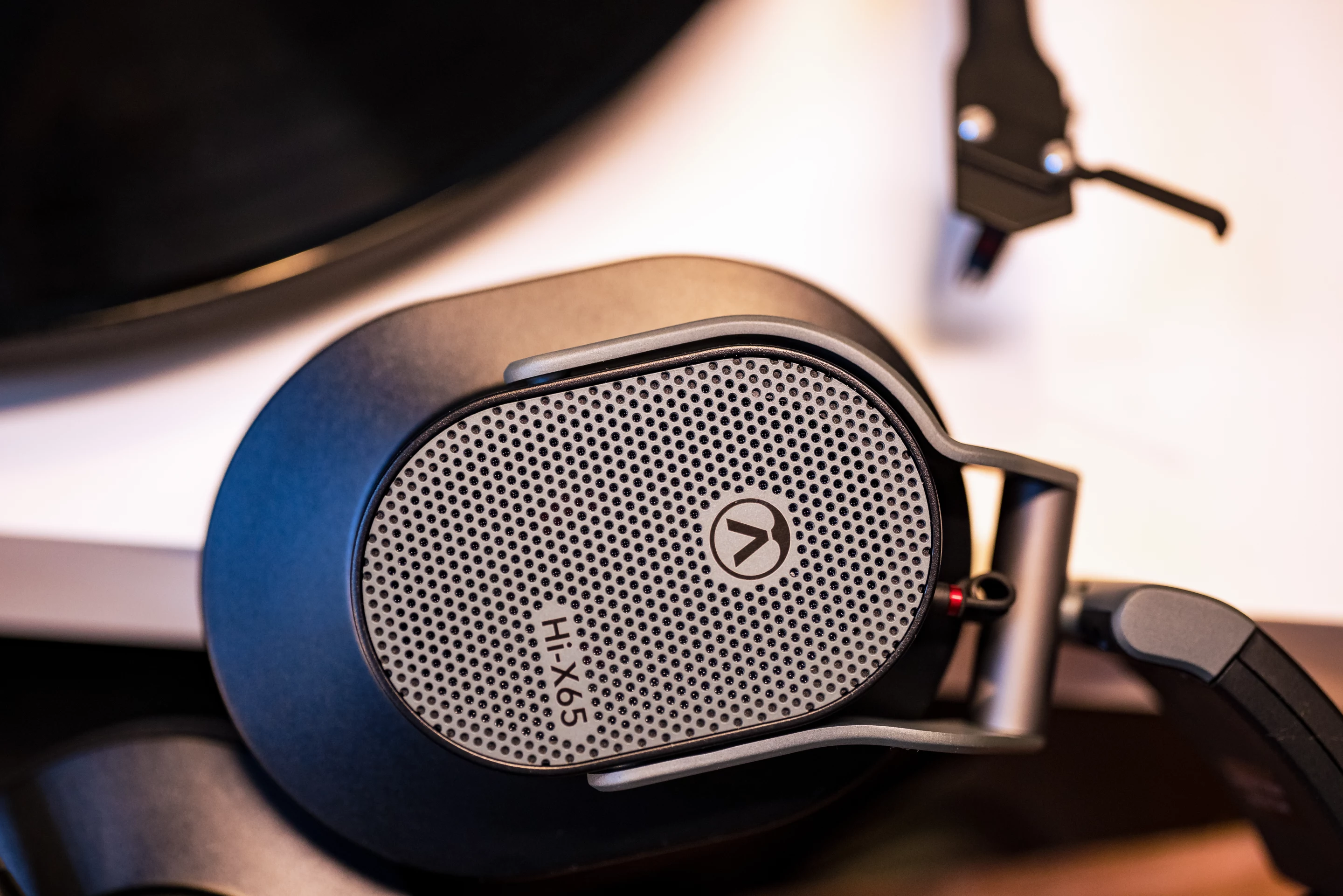 The Hi-X65 headphones are reported to offer a large, transparent soundstage with impressive bass imaging and low distortion