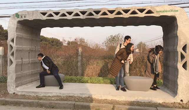 Passengers admire WinSun's 3D-printed bus shelter