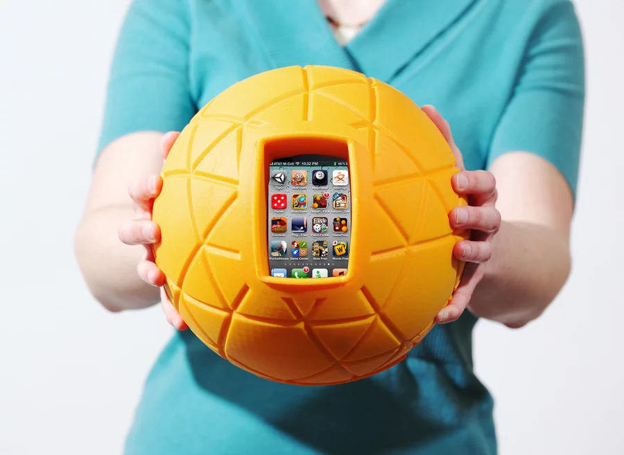 TheO Ball is designed to hold your phone within its cushioned grasp, allowing you to literally throw your phone around to play games without fear of damage
