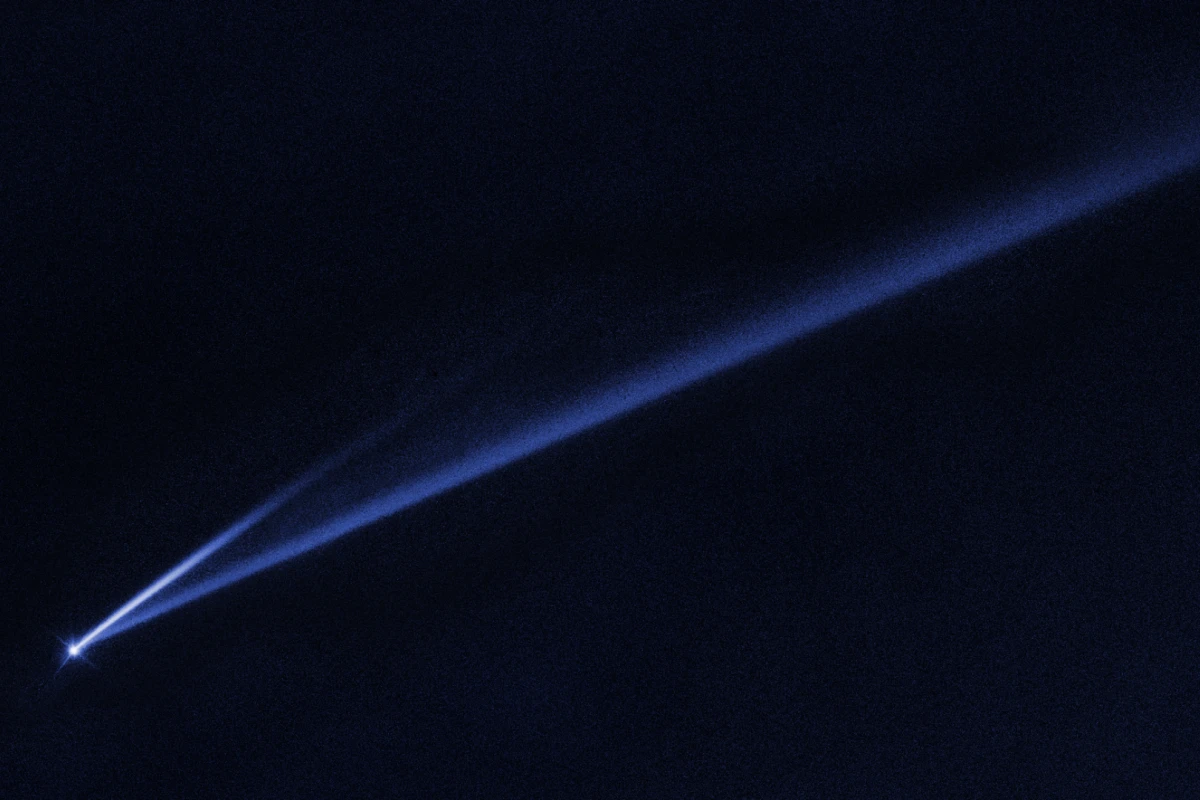 A Hubble Space Telescope image revealing the gradual self-destruction of an asteroid, whose ejected dusty material has formed two long, thin, comet-like tails