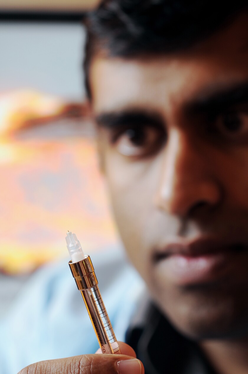 Researcher Samirkumar Patel displays a prototype microneedle