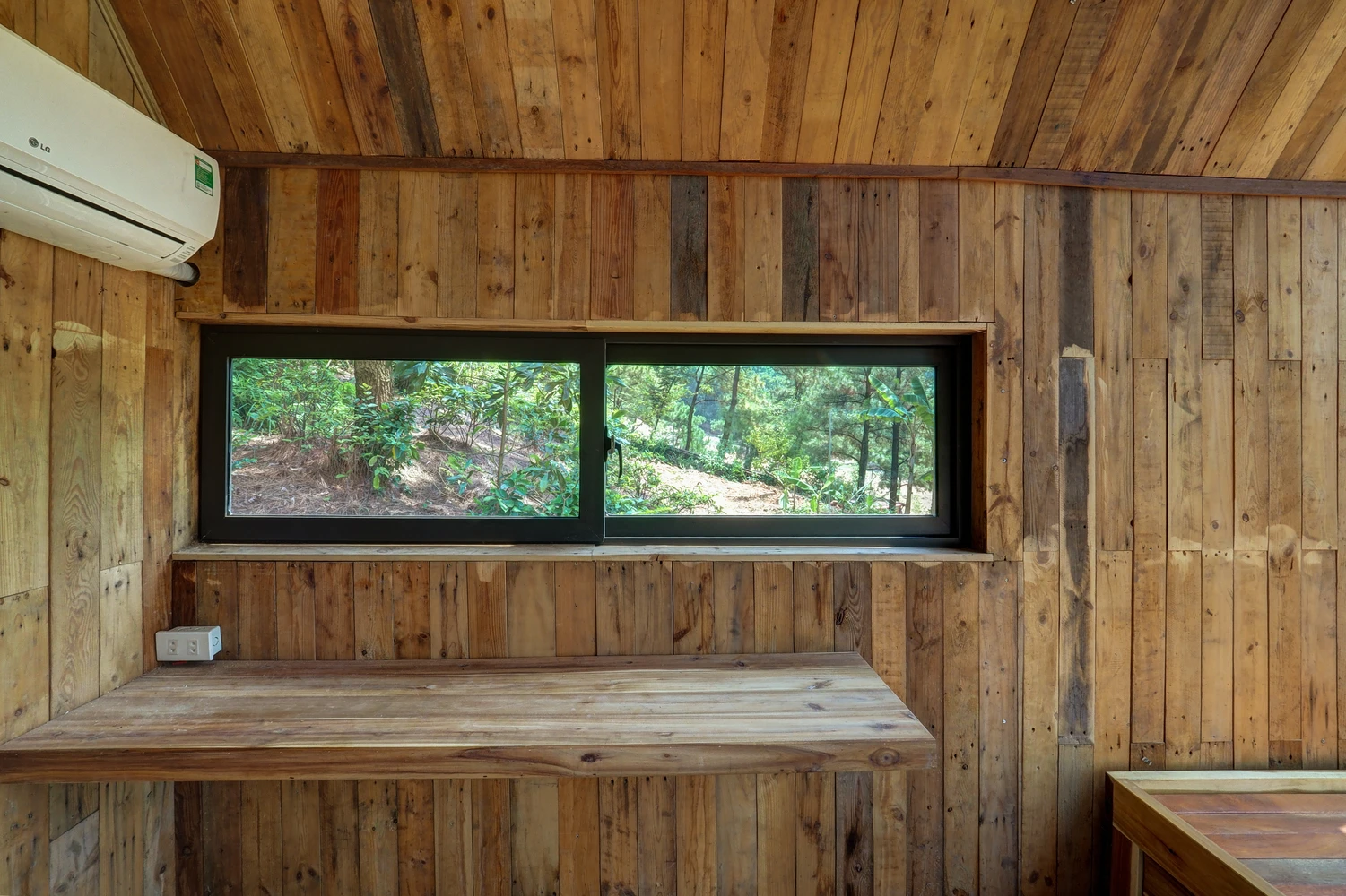 Forest house features in-built furniture, including a desk or dining table