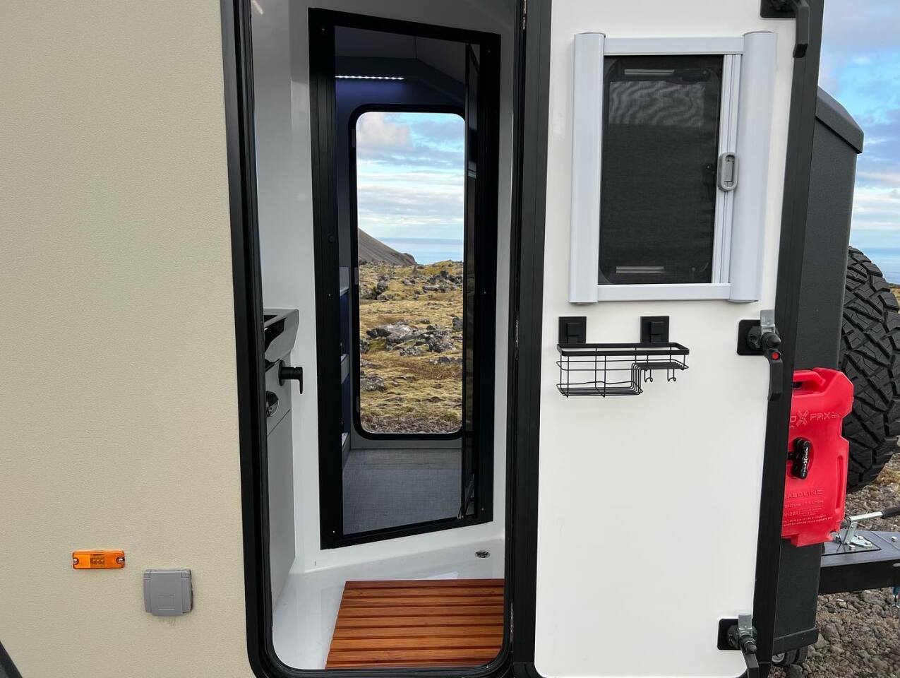 With indoor and outdoor access, the wet bathroom doubles as a mudroom perfect for cleaning off before entering the main cabin