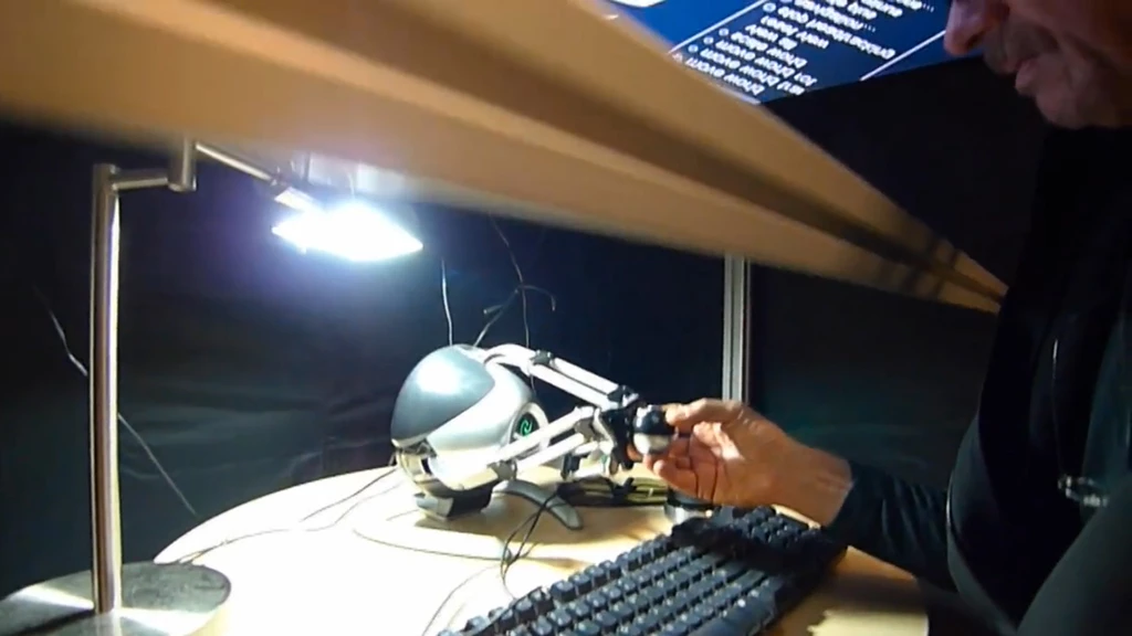 The touch-feedback device located underneath the half-silvered mirror
