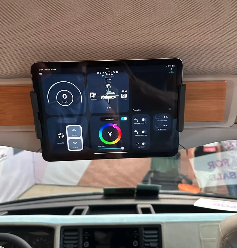 Camper Schmiede uses a smart home-style app from Revotion for interior control and monitoring; the app runs on smartphones and tablets, such as the included control tablet that docks over the cockpit