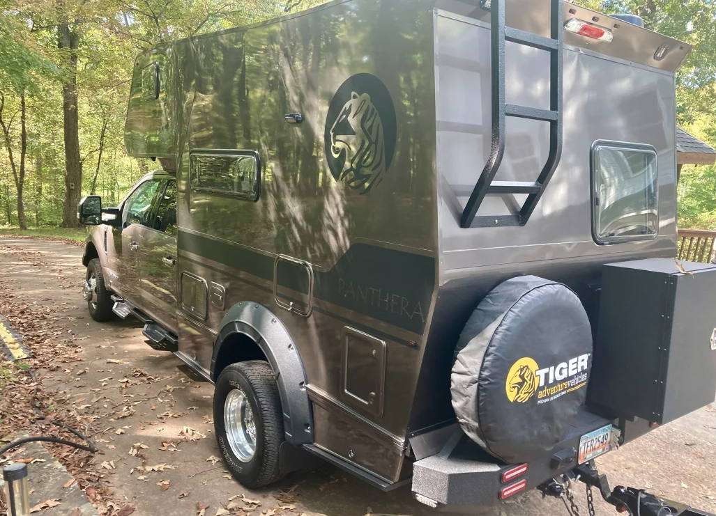 The custom rear bumper with tire mount and swing gate comes standard, the storage box optional