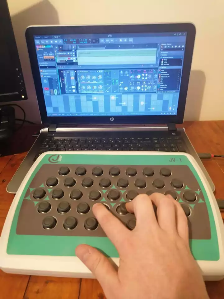 The JV-1 MIDI controller can be cabled to a laptop running music production software over USB