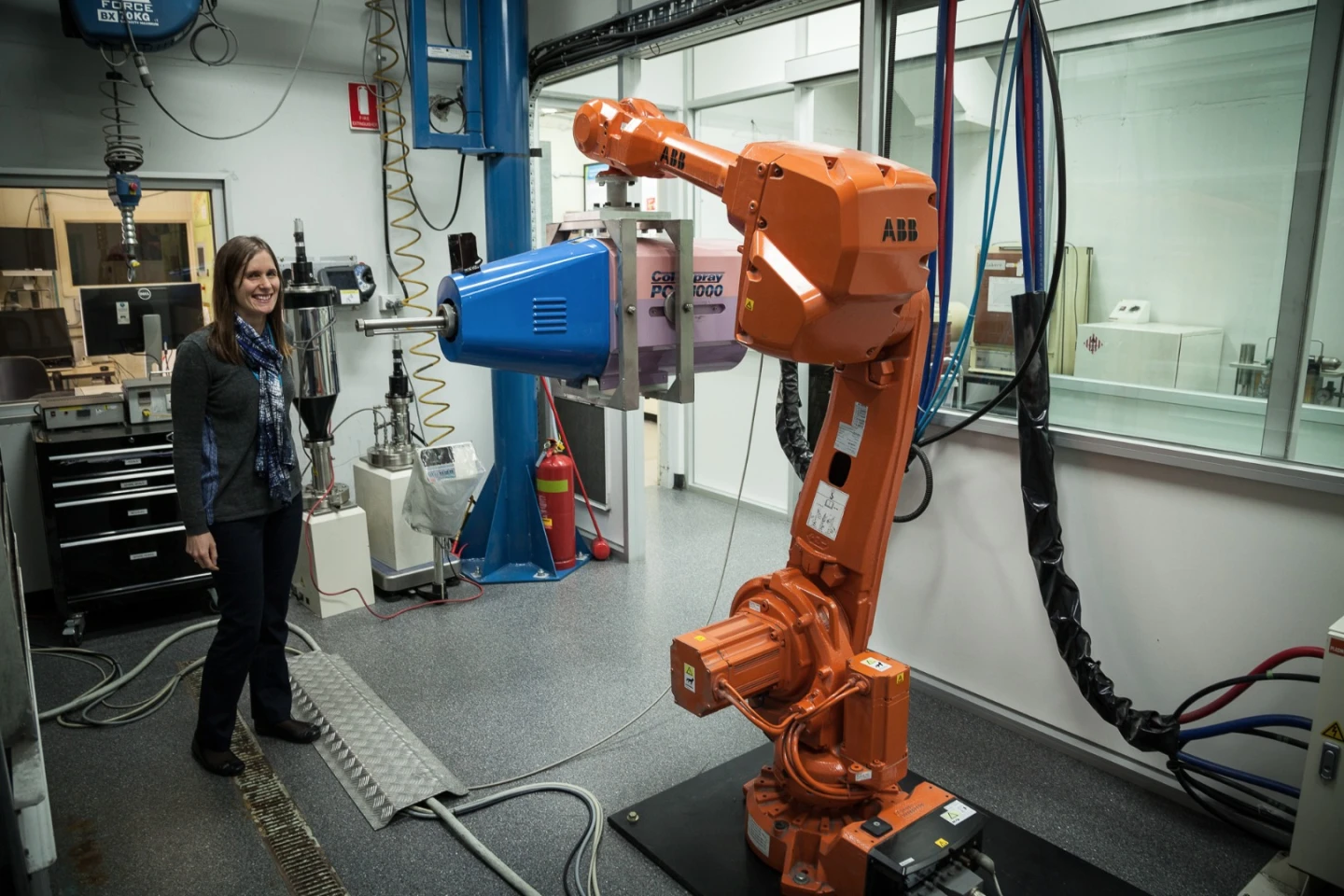 Lab 22's Alexandra Kingsbury with the group's Cold Spray Plasma Giken machine, mounted on a robot arm
