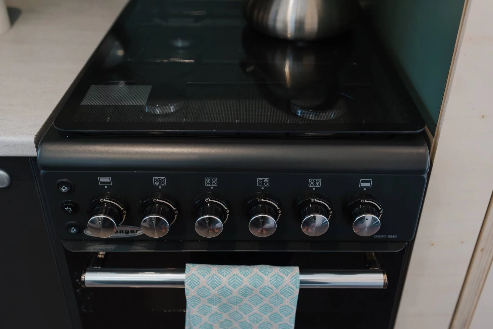 La Sombra Tiny House's kitchen includes a propane-powered oven and four-burner stove