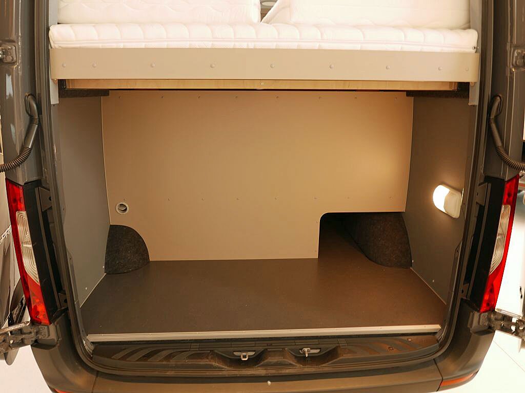 The rear load area includes a small passthrough for skis, poles and similar
