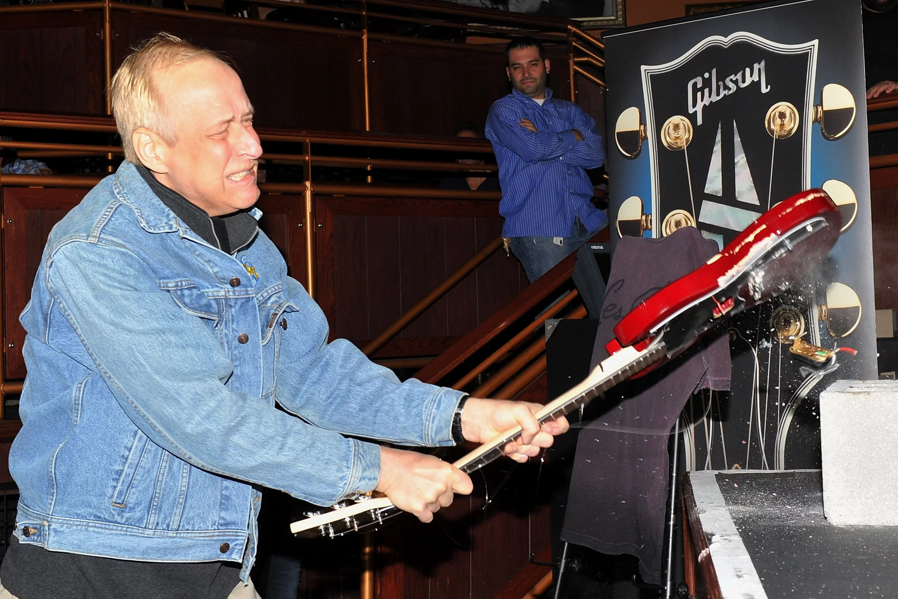 Gibson CEO Henry Juszkiewicz smashes a guitar to pieces at the launch of the Firebird X in New York