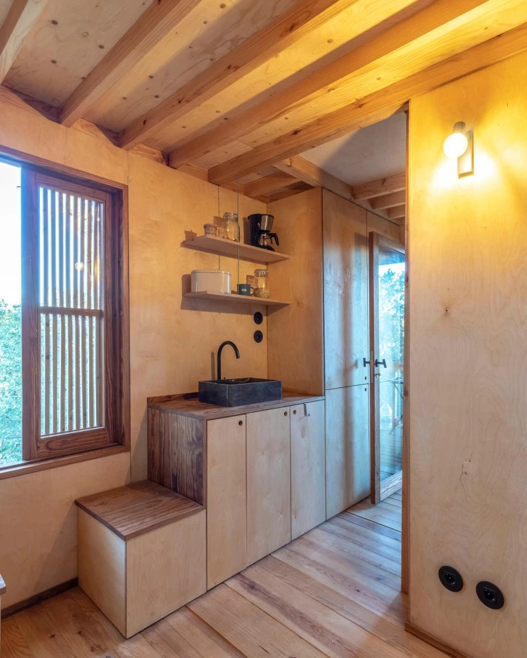 The Columba's kitchenette is very simple and includes a sink, shelving, and some cabinetry