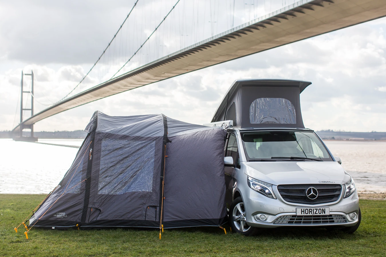 The exterior tent add-on creates a covered cooking/dining/storage area