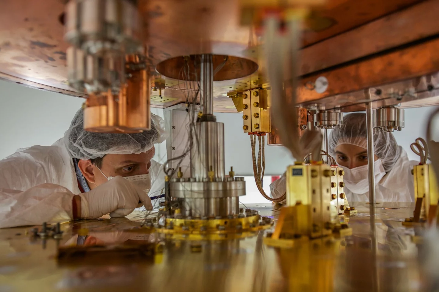 Researchers working on the cryostat