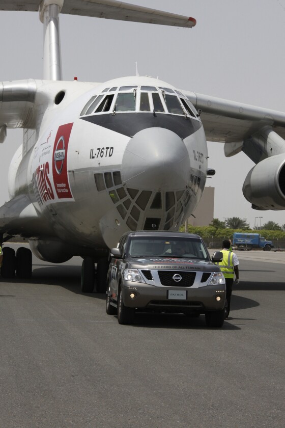 The Nissan Patrol towing the 170.9-ton cargo plane to claim the "heaviest object pulled by any production vehicle" Guinness World Record