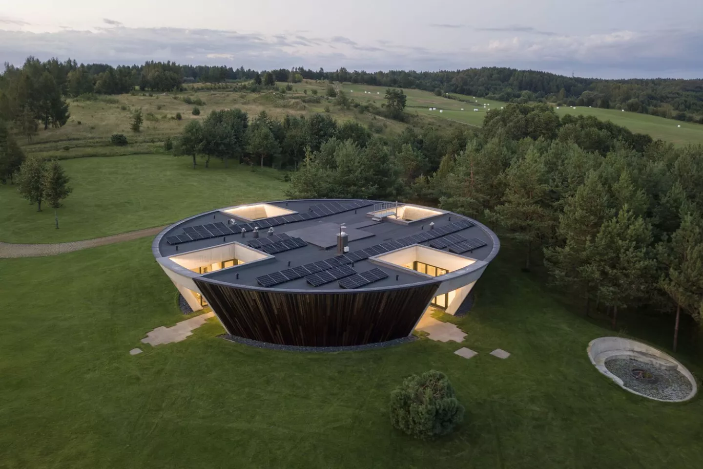 Circular home built around multiple sunken gardens
