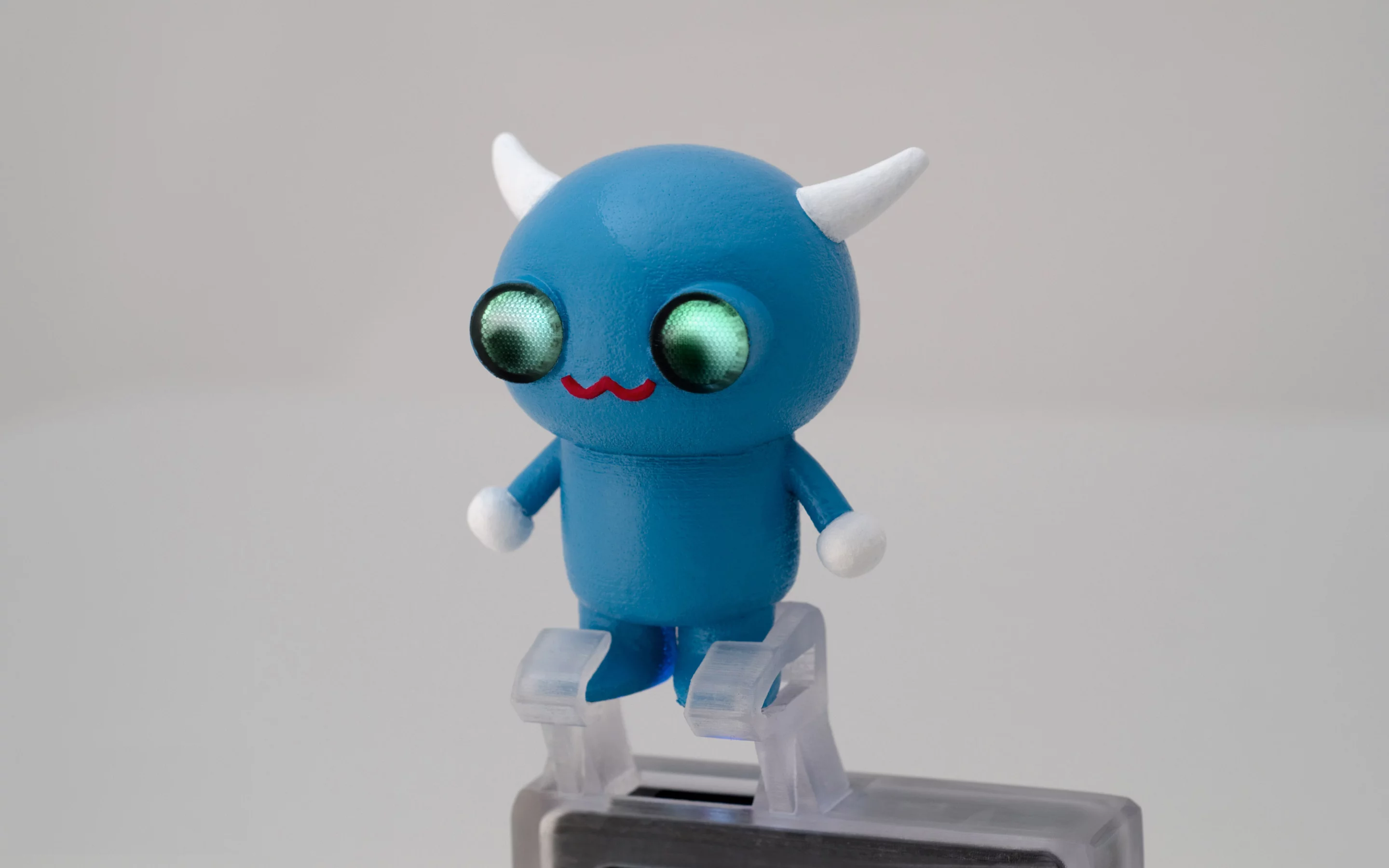 A 3D printed mobile projector accessory with embedded light pipes that direct light to the character's eyes