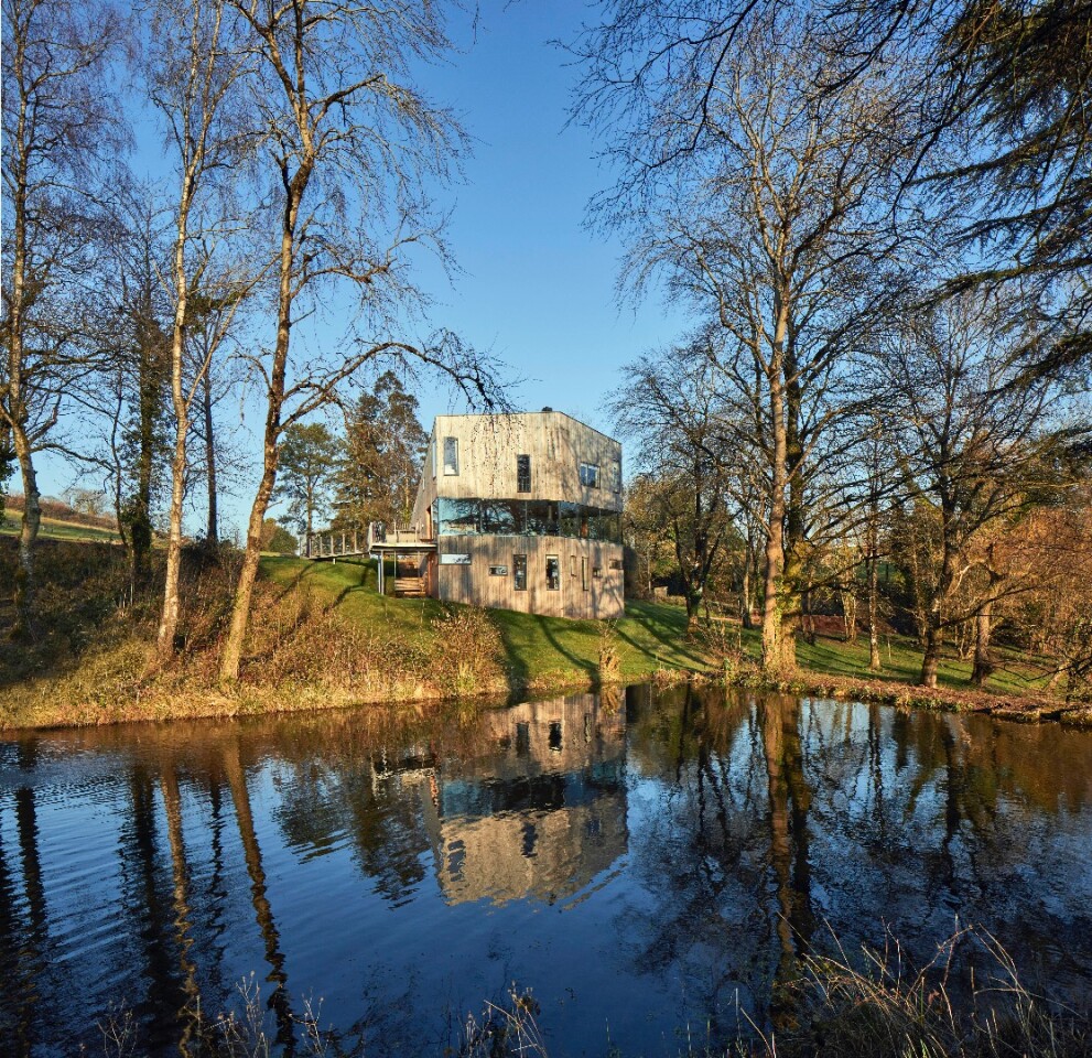 "The plan and roof form is freed from the rectilinear, and the flow of space up the staircase to a library window seat is delightful," says RIBA . "The use of fine plaster and ply veneer is restrained and balanced, highlighted with spalted wood stairs and dining table from timbers from the estate. The bedrooms are arranged for privacy, with simple thoughtful joinery detailing"