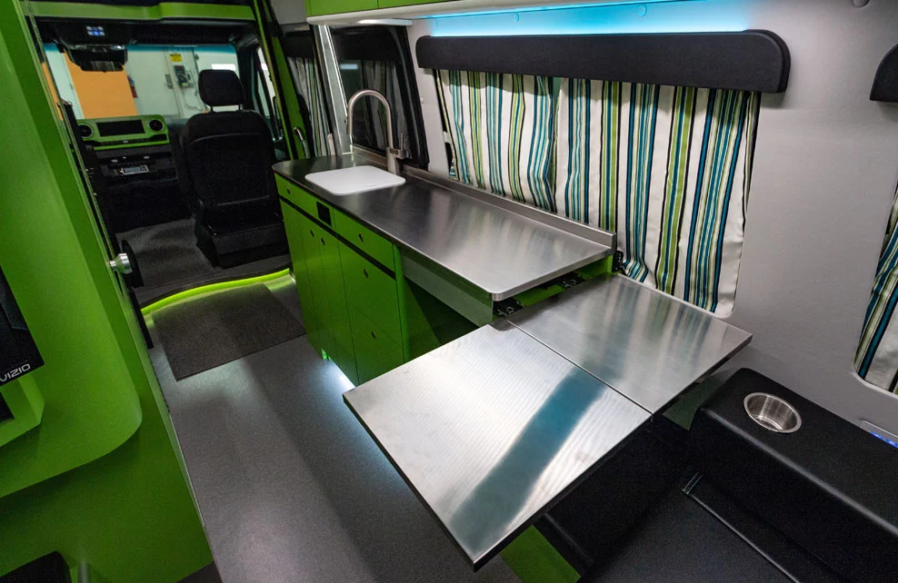 The dining table slides and folds out from below the countertop, doubling as a counter extension