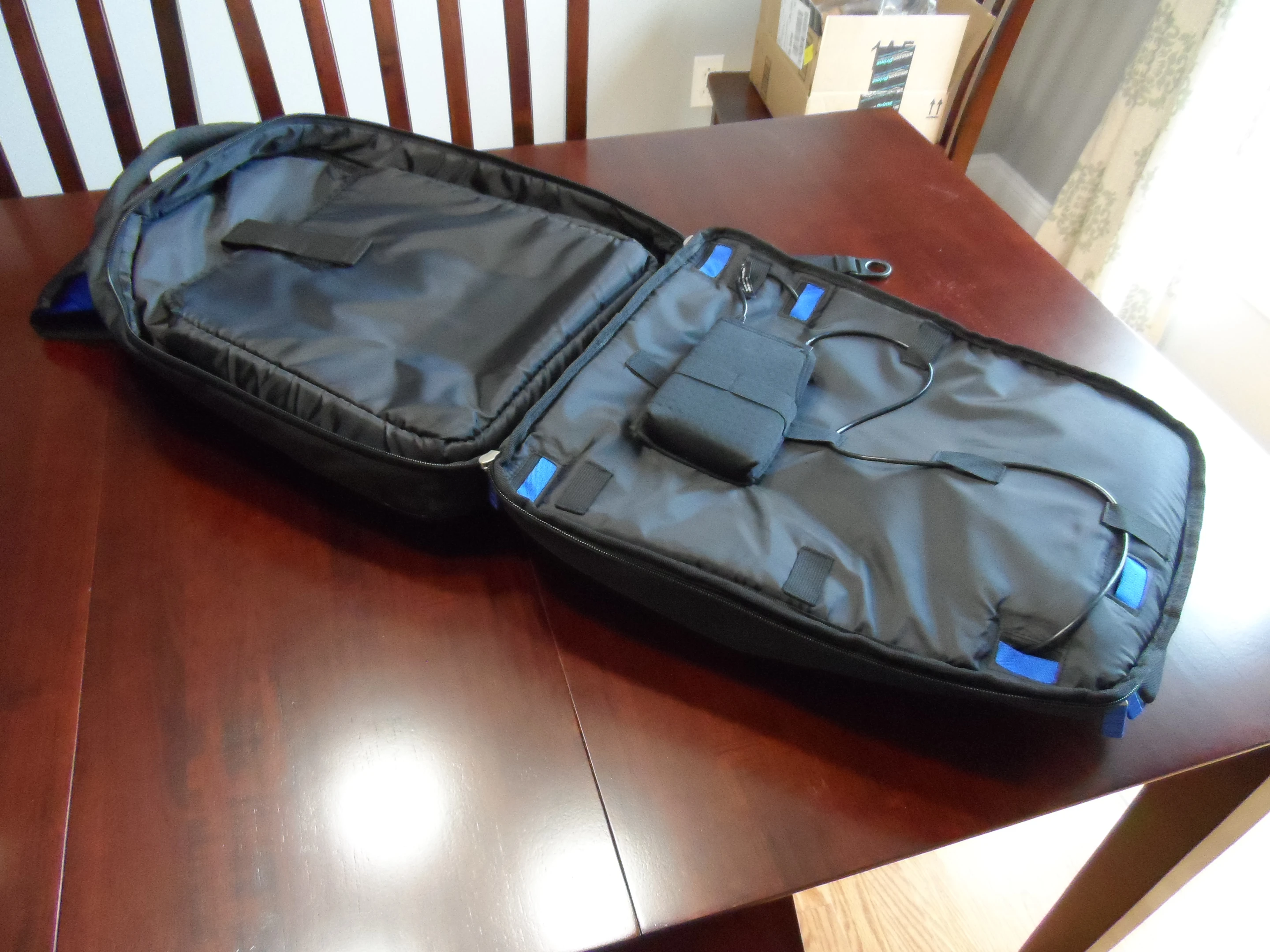 The backpack open all the way with a view of the battery