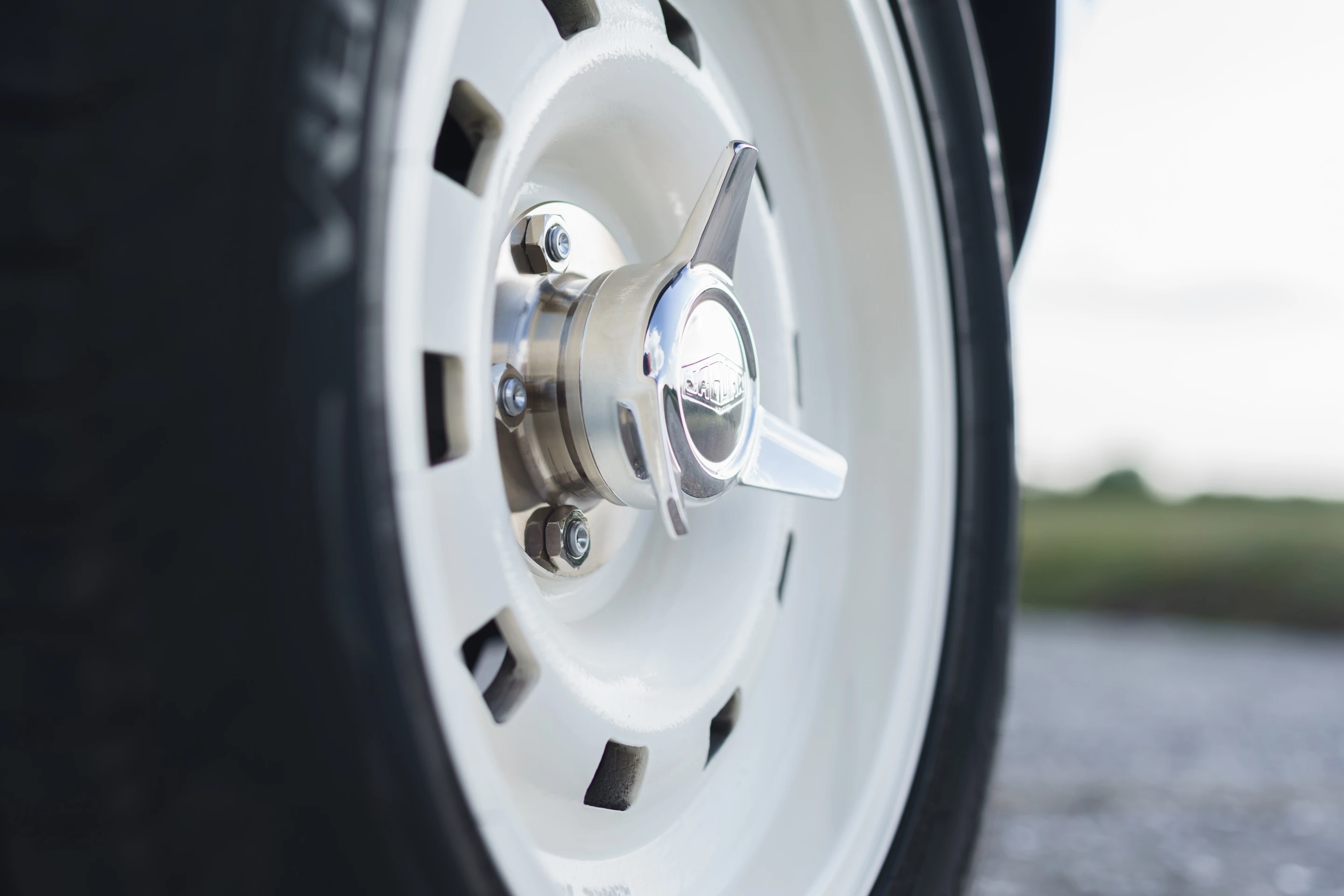 16-in peg-drive magnesium-alloy wheels held on by three-eared aluminum spinner nuts