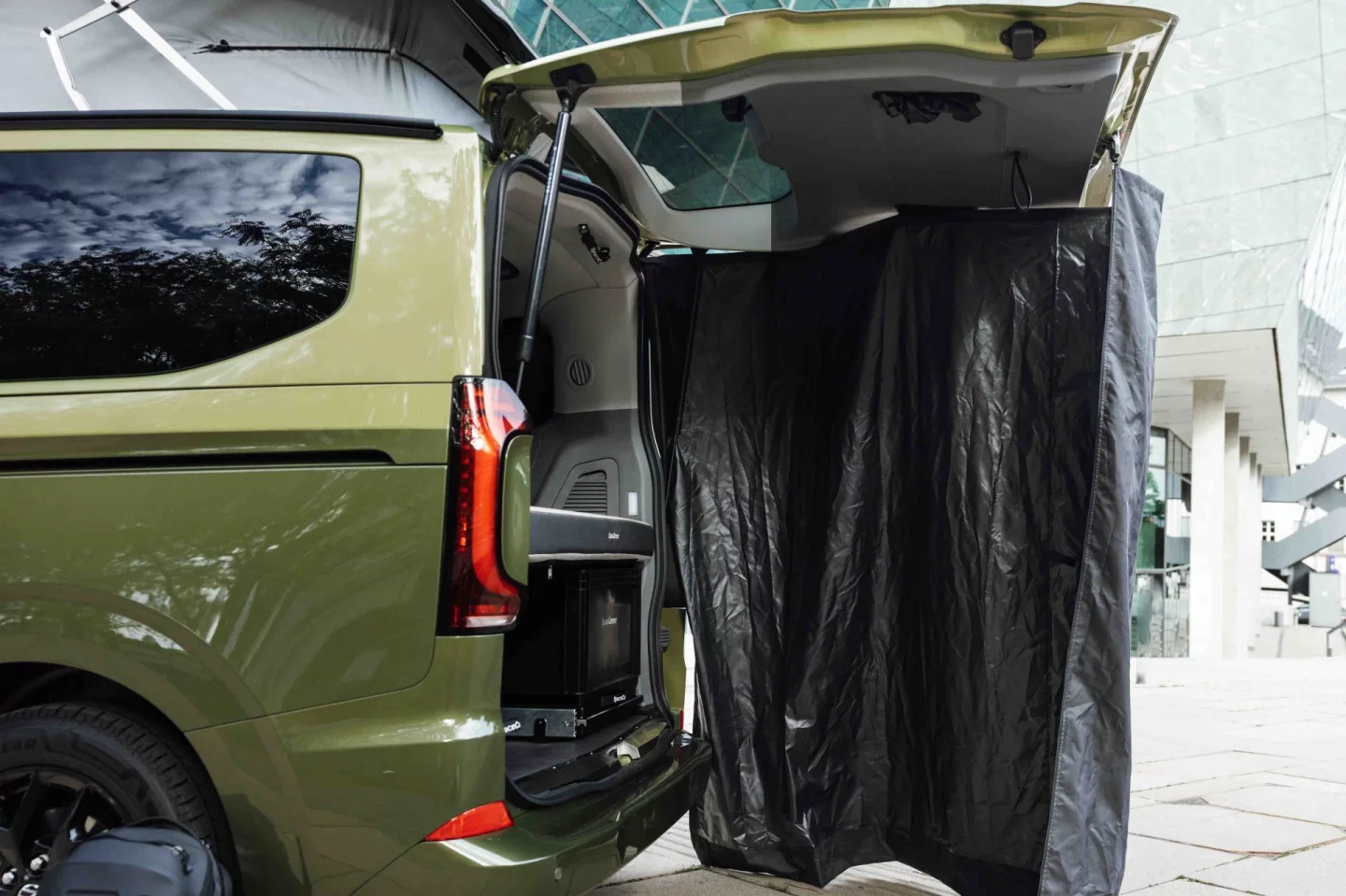 A drop-down rear tent serves as a bathroom and change room