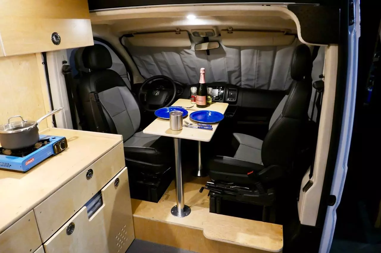 The two-pedastal dining table sets up between the seats, rather than farther back in the cabin like many camper vans