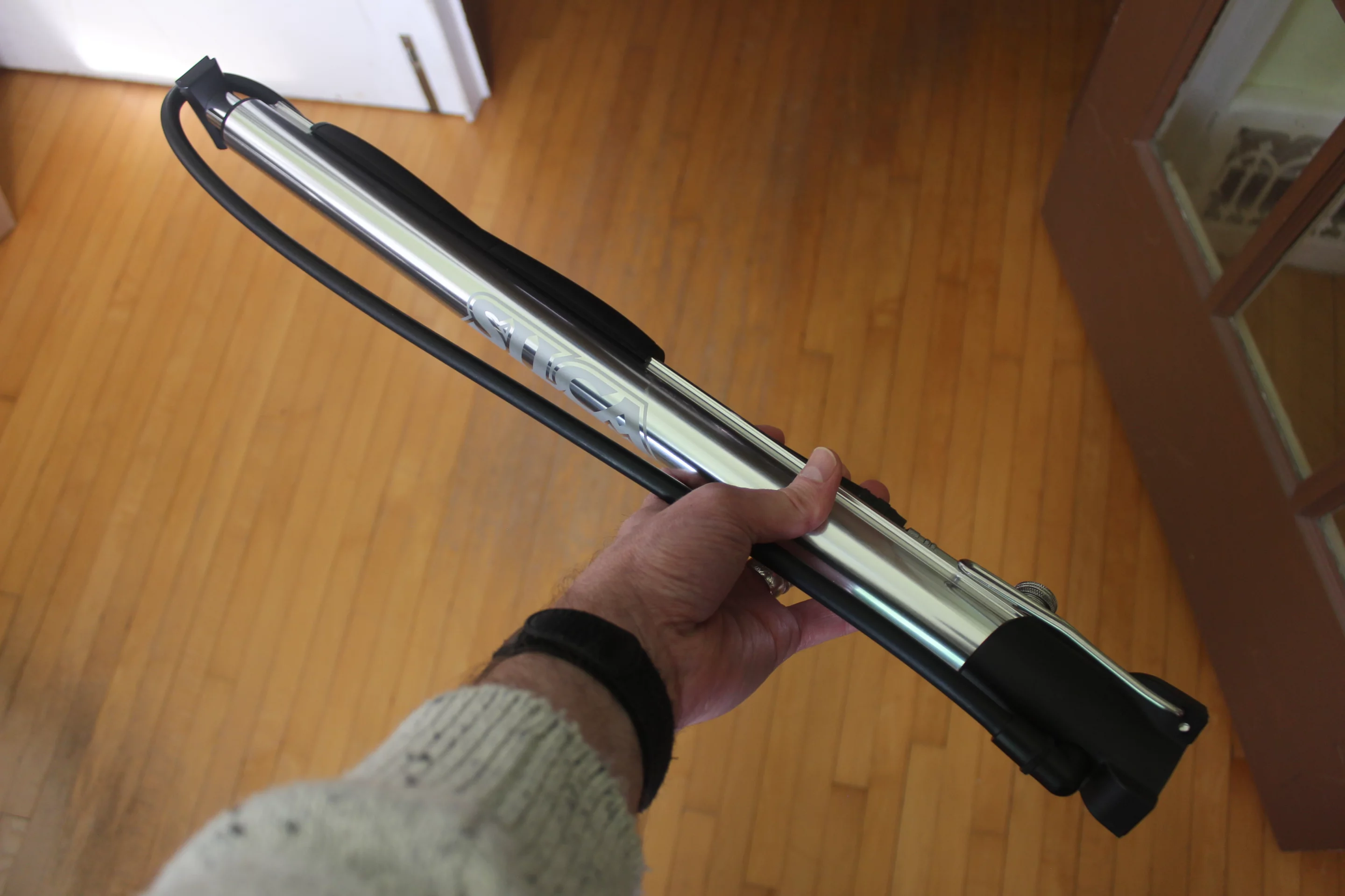 Once it's time to travel, the feet are folded up, and the Silca Viaggio's solid aluminum handle is slid off of the piston and onto a barrel rail, where it's used to hold the hose in place