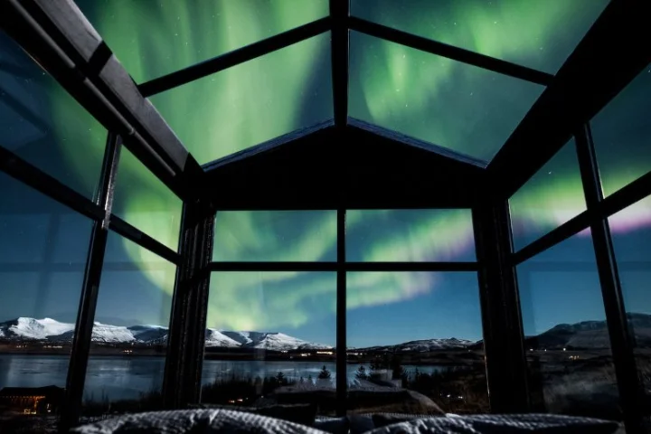 The Panorama Glass Lodge is crafted largely from wood, but at one end floor-to-ceiling windows open it up to the surroundings
