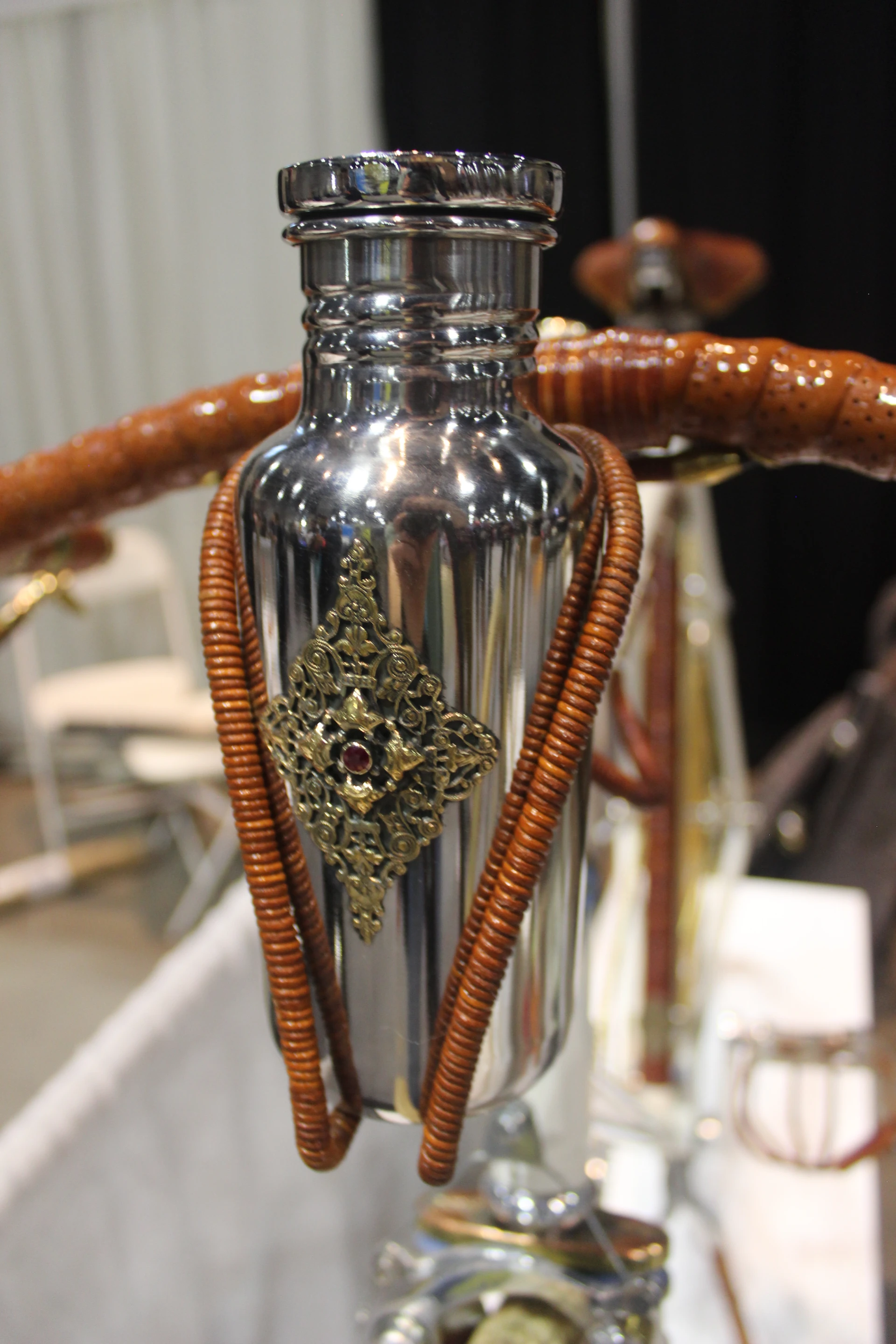A leather-wrapped bottle cage and custom bottle, by Ascari Bicycles