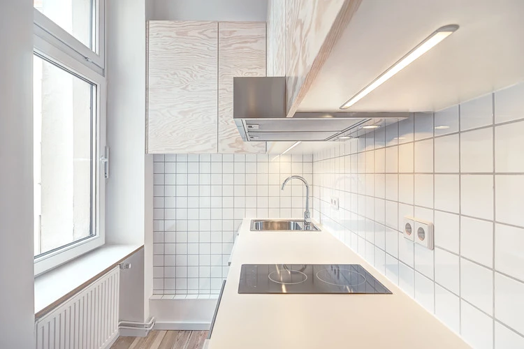 The kitchen in the Micro-Apartment Moabit is contained in short corridor