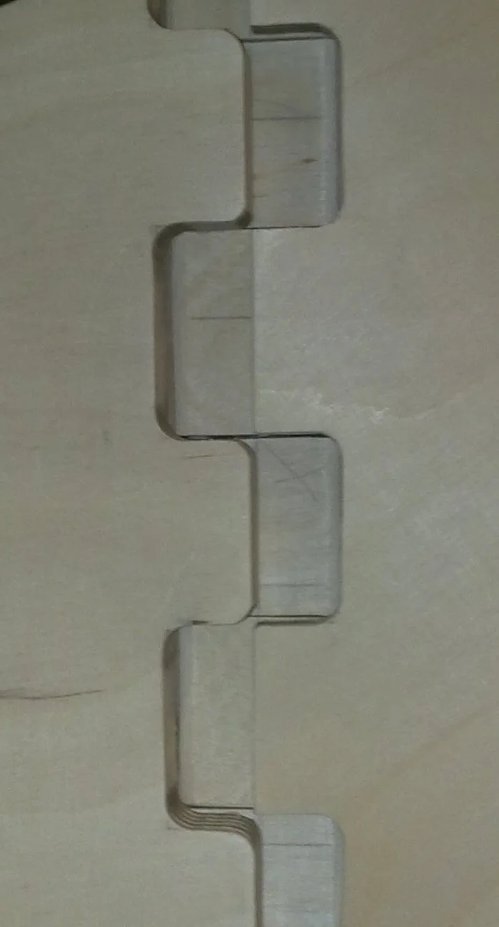 Close up of the steering mechanism, which is described as a chunky plywood butt hinge
