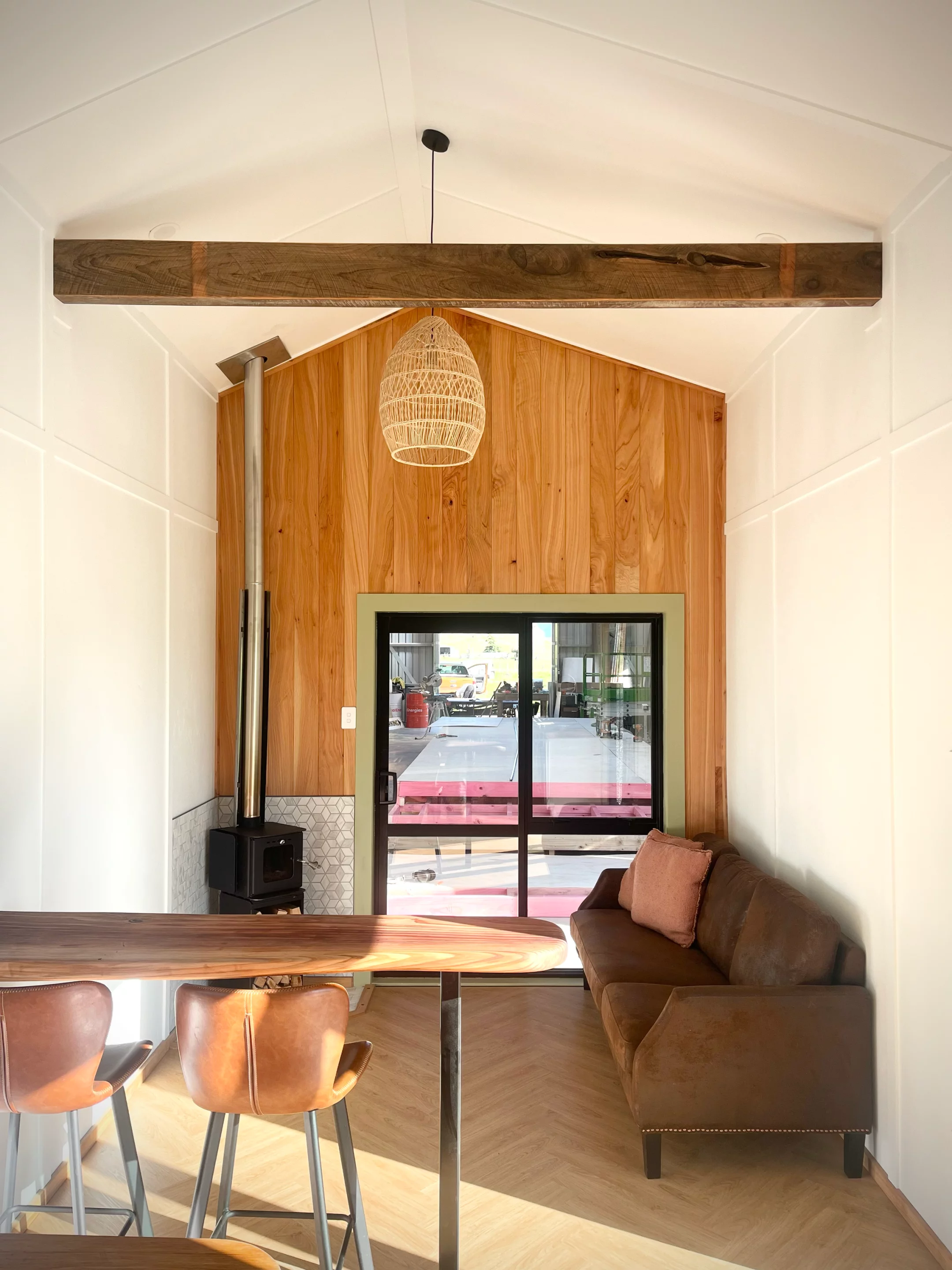 The Redwood's living room has a high ceiling and is filled with natural light thanks to the generous glazing