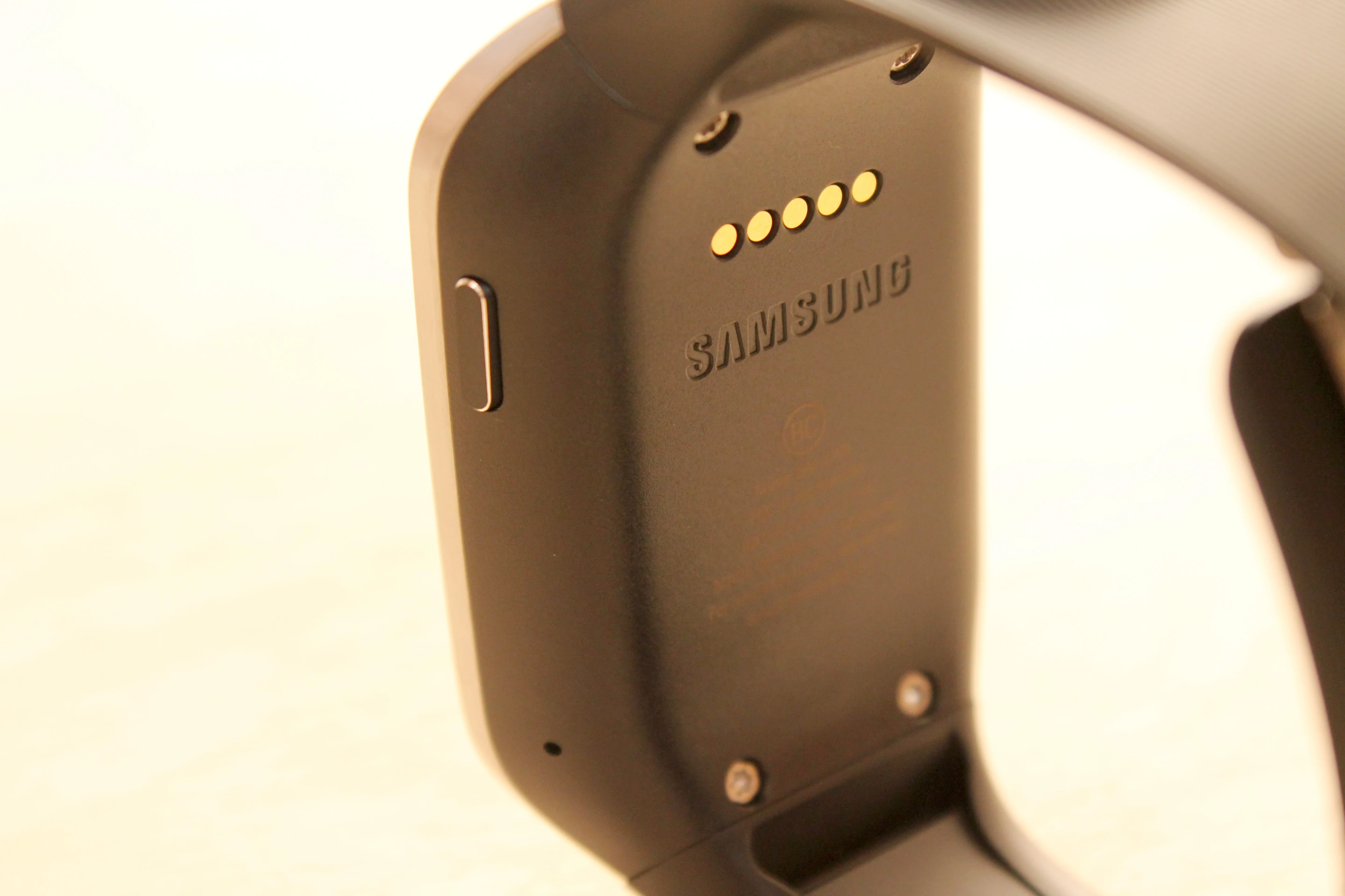 Those subtle charging coils on the back connect to the charging cradle (which, in turn, has a microUSB cable)