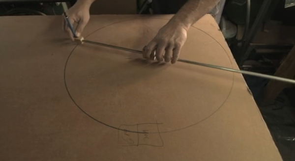 Gafni begins making a cardboard bike by sourcing suitable cardboard and cutting it into the desired shapes to be used as parts