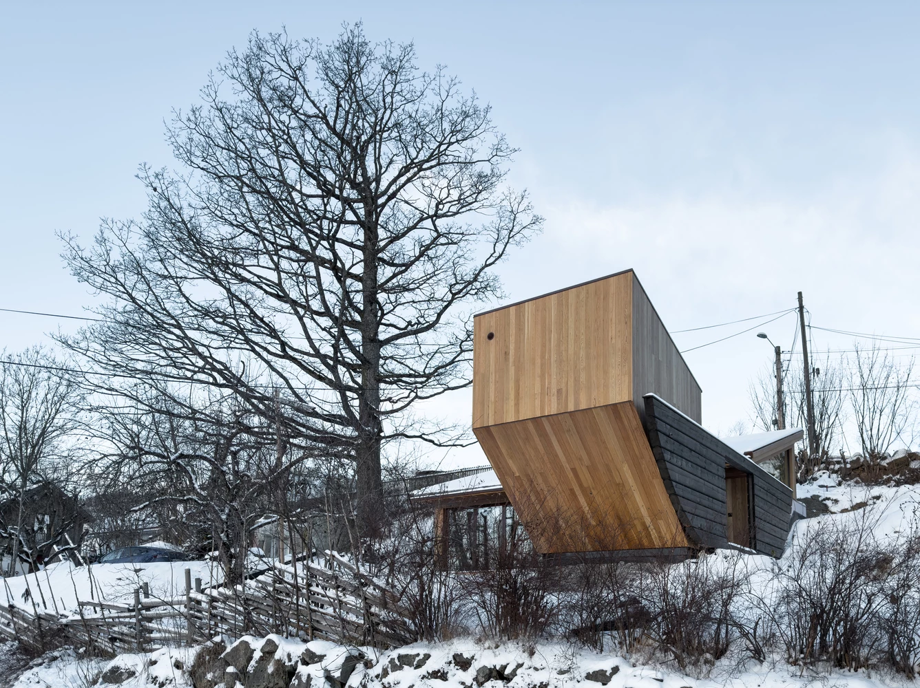 Natural oak panels add warmth and elegance to the exterior