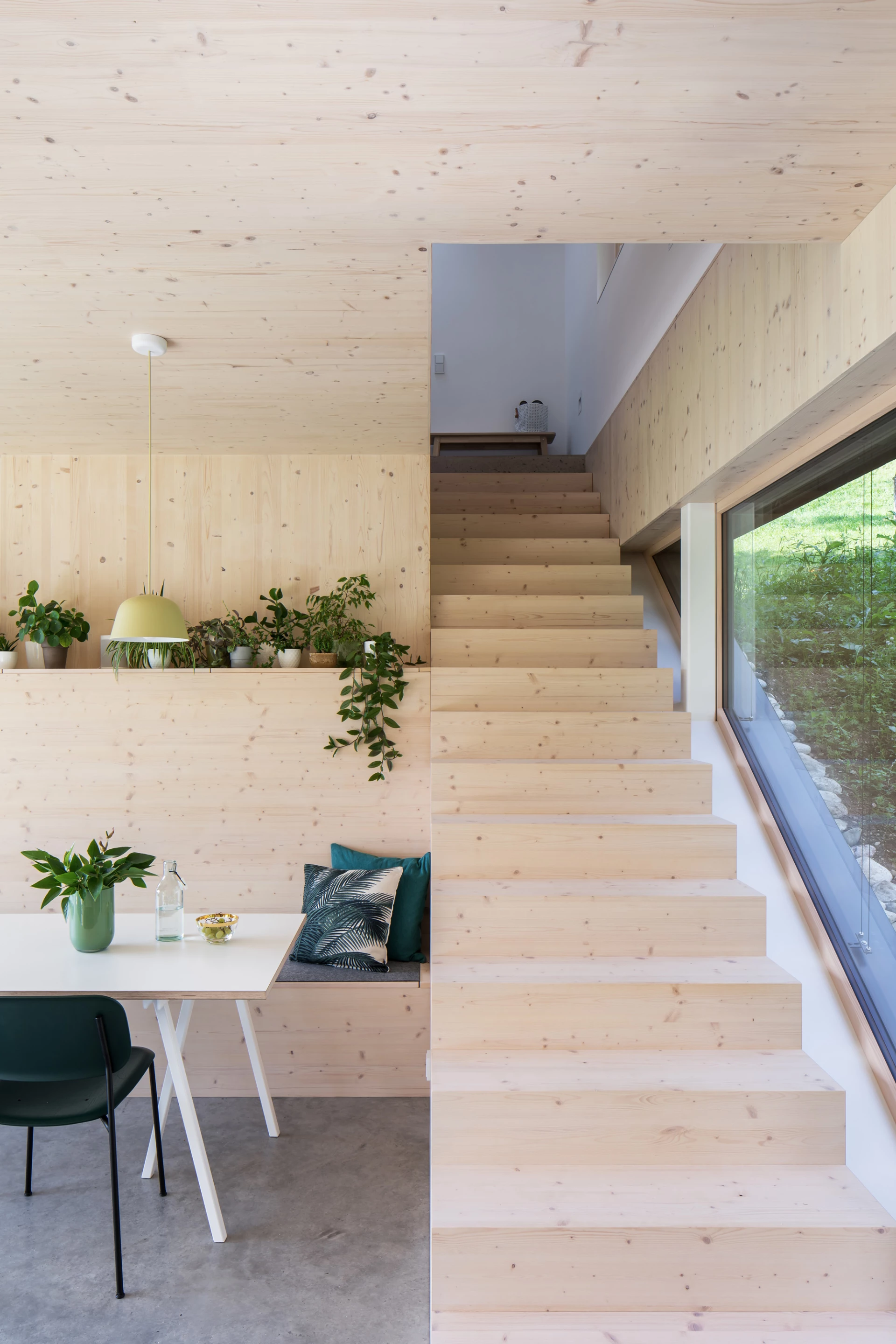 The Mountain House occupies a sloping plot of land in Upper Austria, with thick forest to one side and expansive valley views on the other